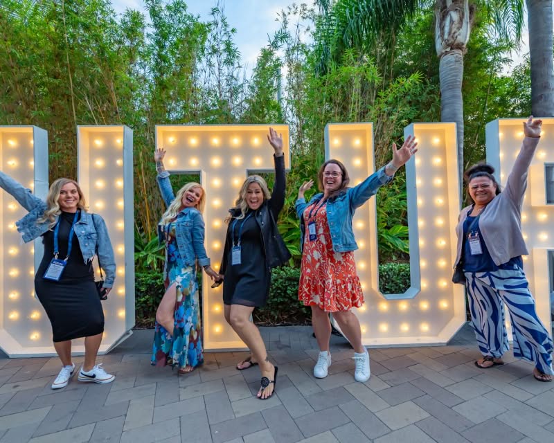 Attendees posing in front of FUTURE sign
