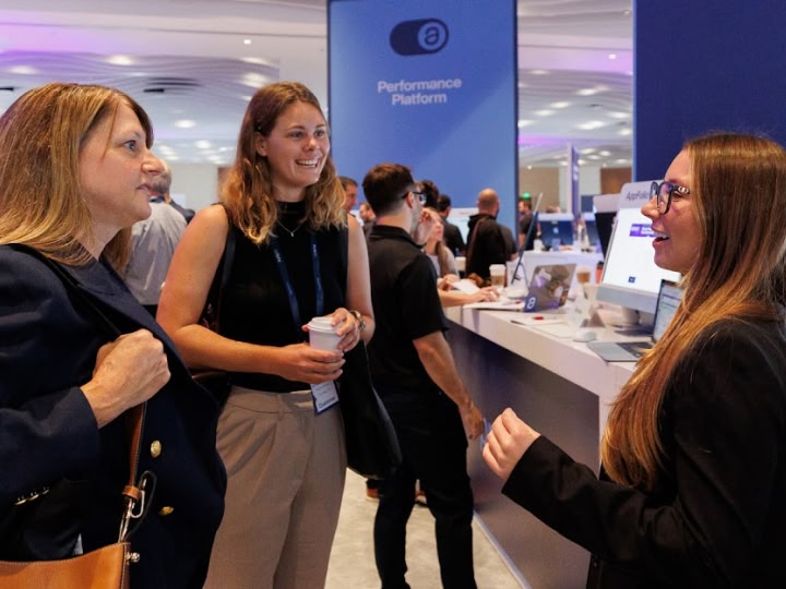 Attendees networking at EXPLORE expo booth