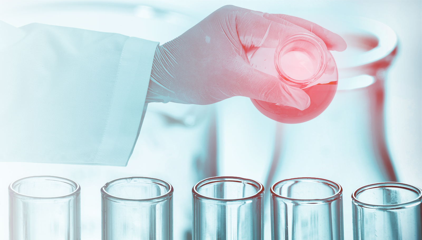 Hand pouring chemical in test tube