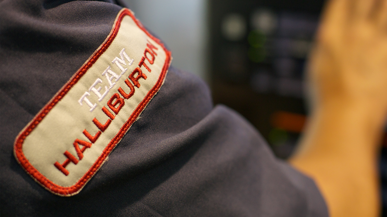 "Team Halliburton" stamp on a shirt sleeve.