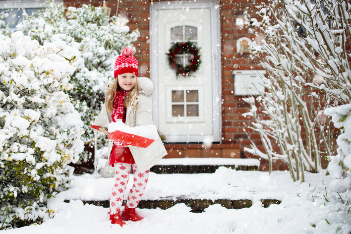 Young girl shoveling snow