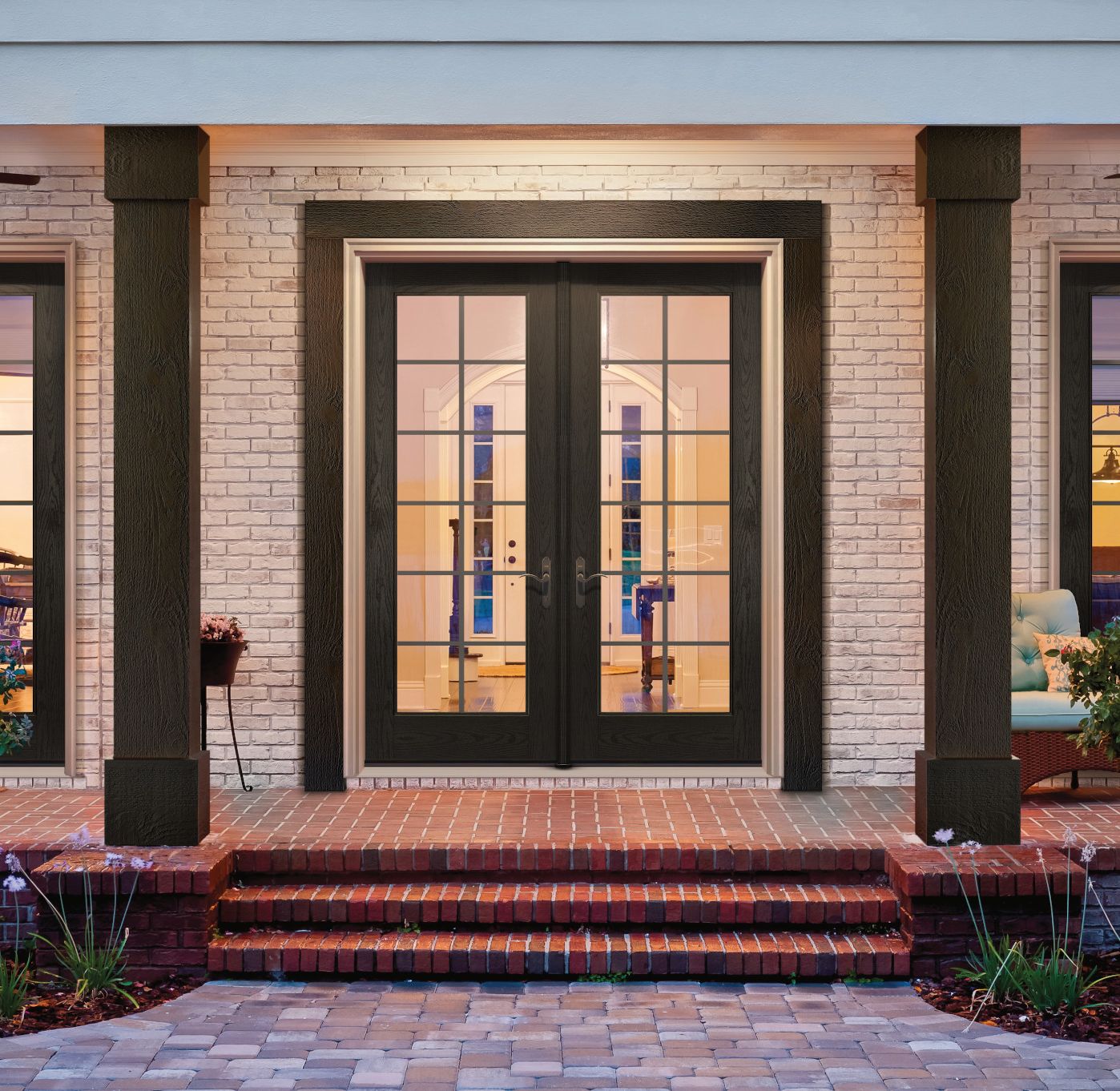 Dark stained entry door on a brick home