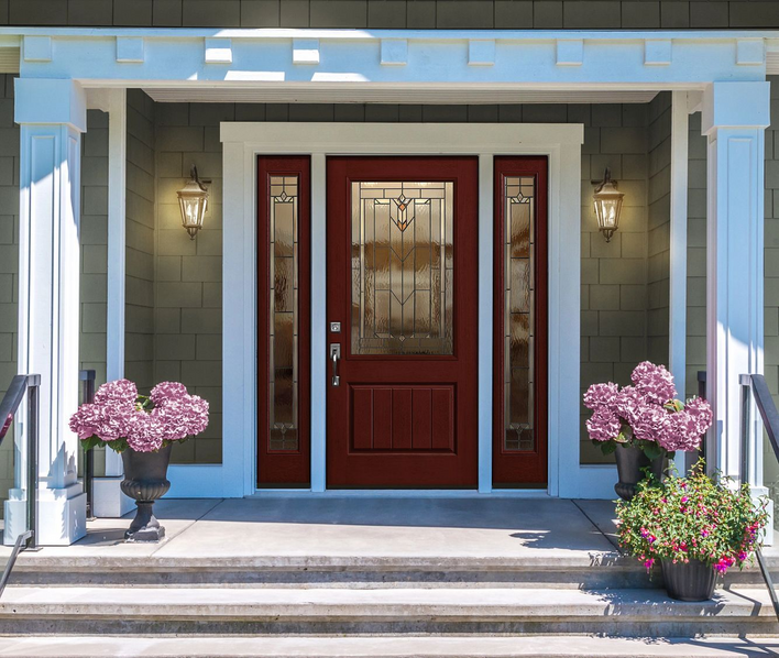 Wine-colored front door on a home with green siding