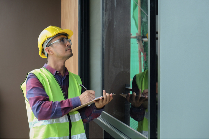 Auditor inspecting home exterior