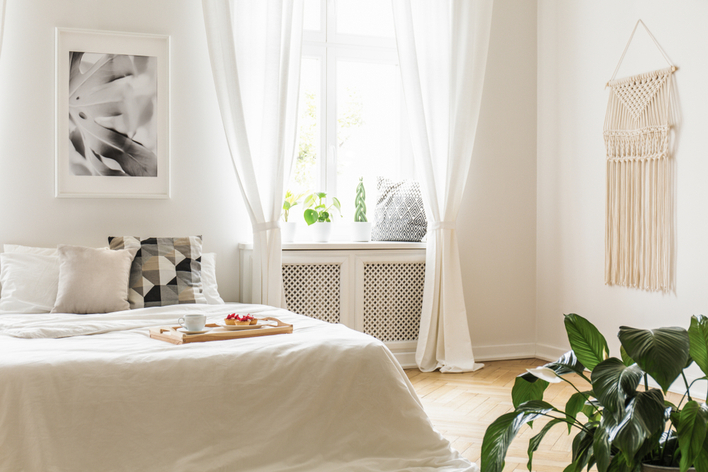 Natural light coming in a bedroom through large windows 