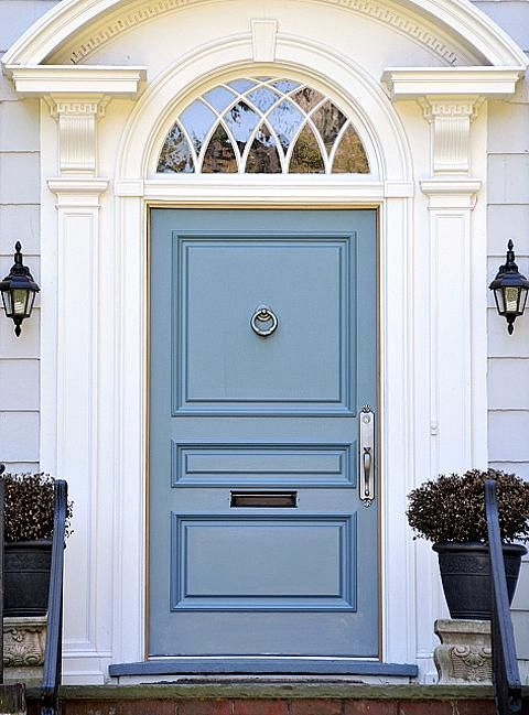 Light blue door on a light gray house.
