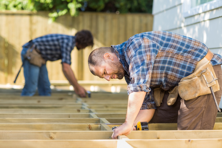 Contractor and subcontractor working on home exterior