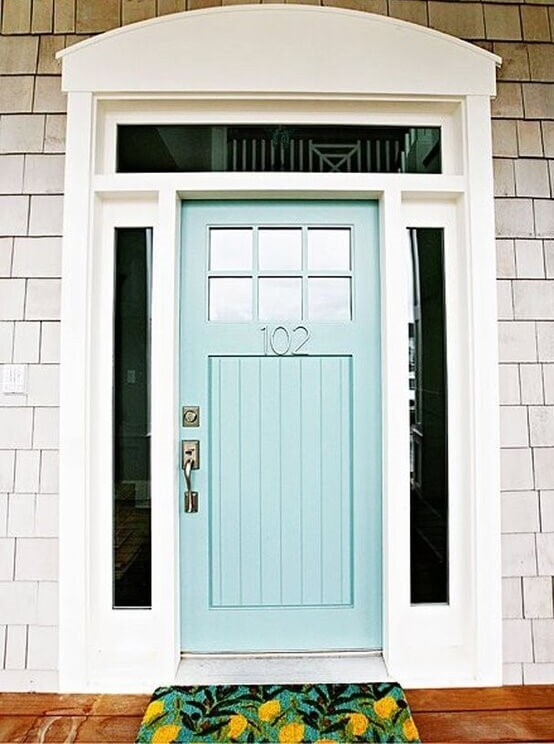 Light blue pastel entry door on a beige house