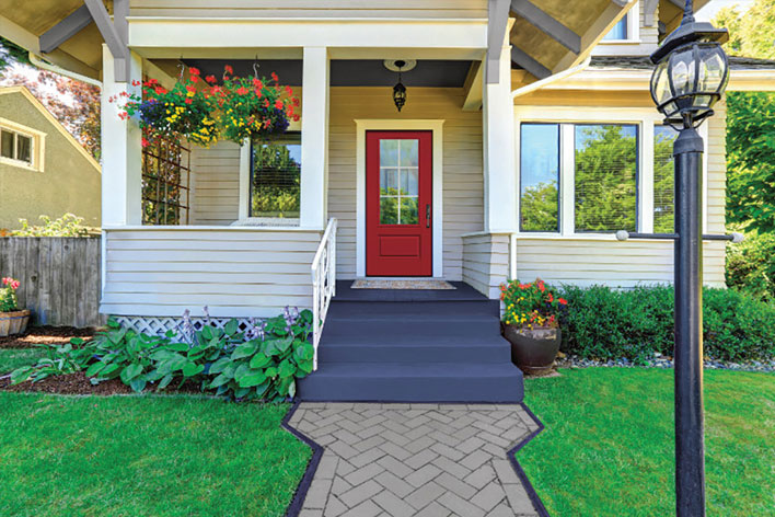 Red front door on the porch of a home