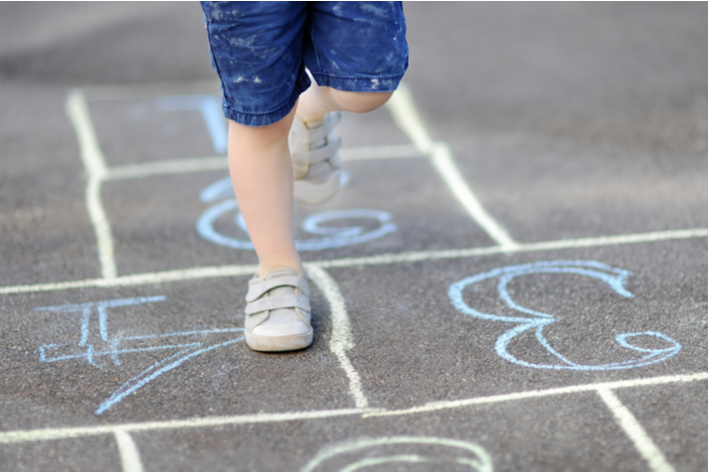 Playing hopscotch on a driveway