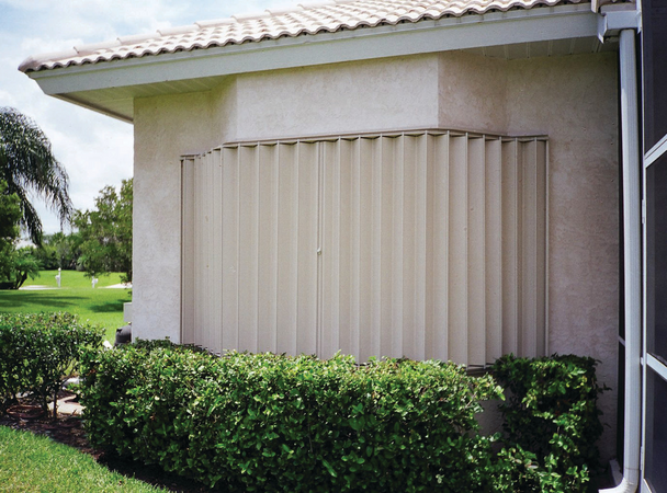 Exterior shot of accordion shutters covering windows