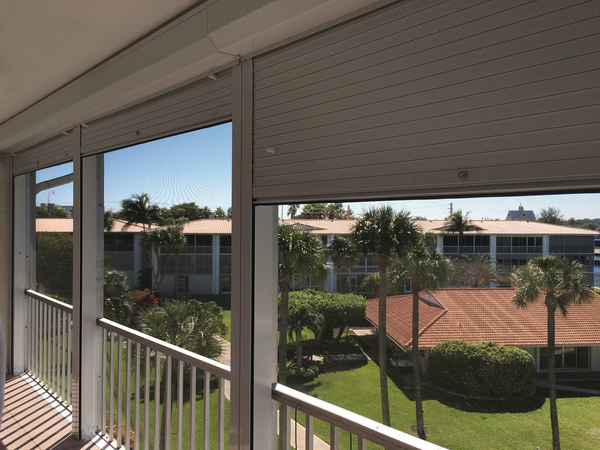 Roll Shutters partially covering a patio of a condominium 