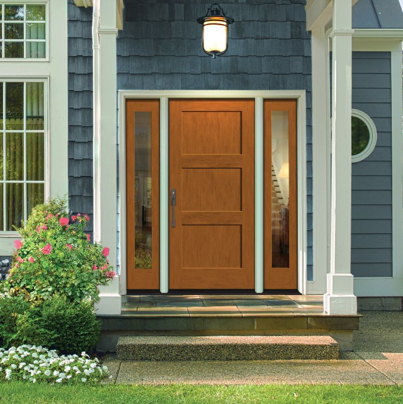 Light woodgrain front door on a blue house