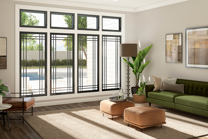 Trendy black-framed floor-to-ceiling windows in a sunny living room