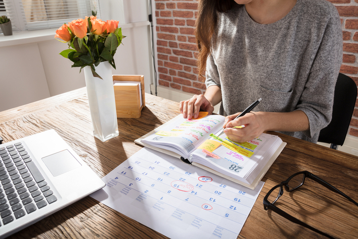 Woman adding tasks to her planner