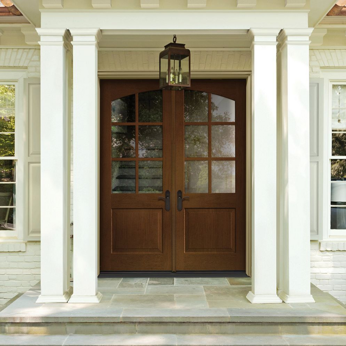 Wood-colored front door with white trim