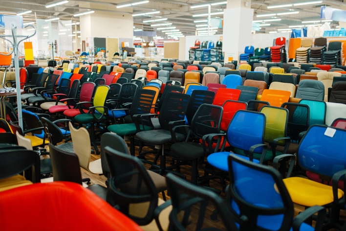 Many office desk chairs in various colors