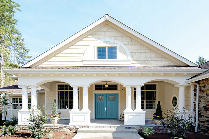 A turquoise front door on a white house