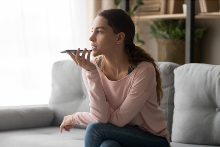 Young woman talking on cell phone in her home