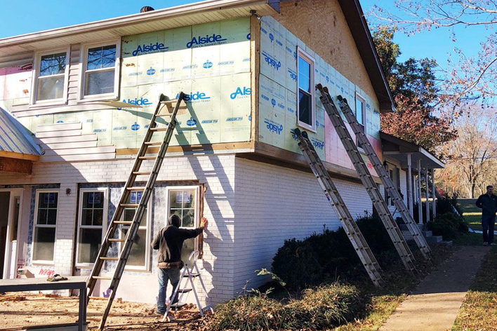 Vinyl siding being removed from a house