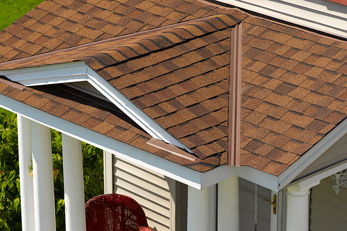 A gabled entryway over the front door is added for the remodel of a ranch home