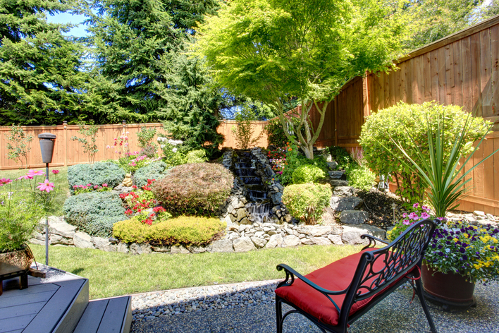 Backyard with a water feature and a sitting bench