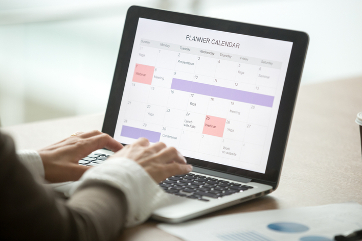 A person planning things on a computer calendar