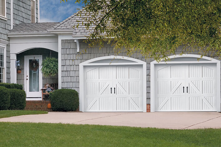 Closed garage doors with cars parked inside