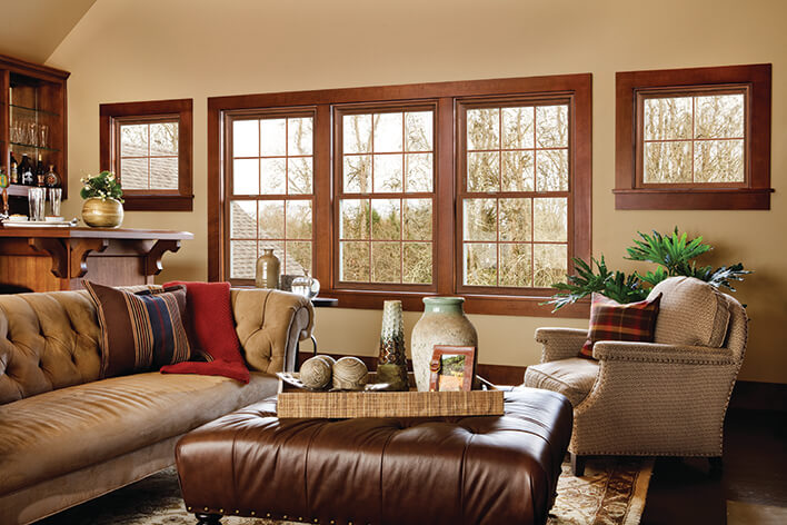 Natural wood framed windows are used to remodel a ranch home living room