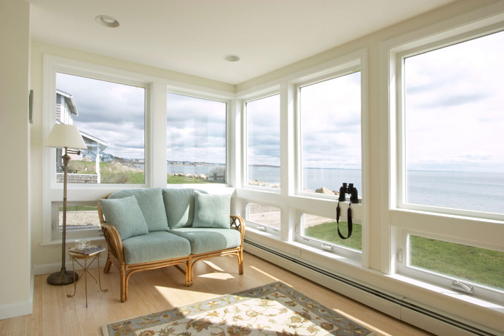 A beach house living room with large windows