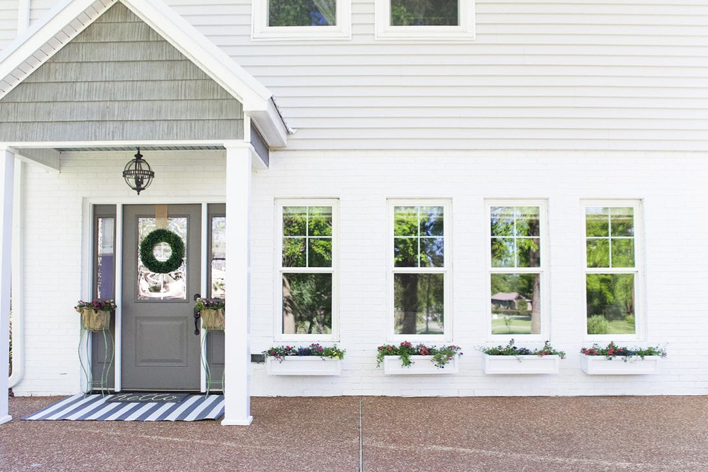 Side view of a white house with grey trim