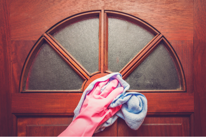 A person cleaning an exterior door