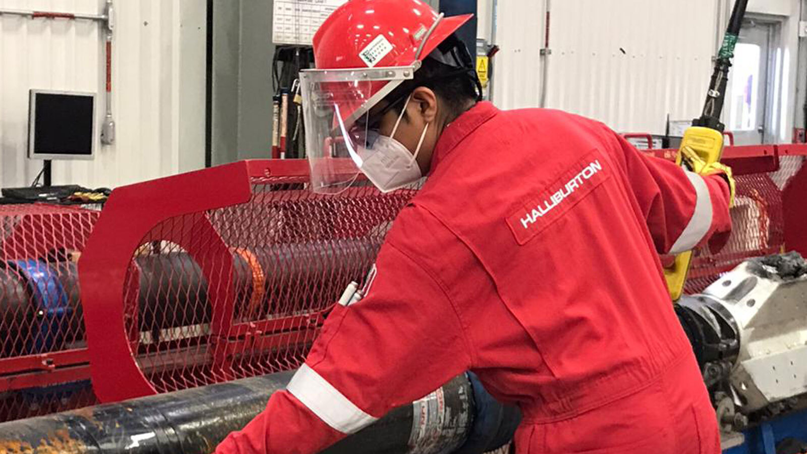 Halliburton employee working on tools