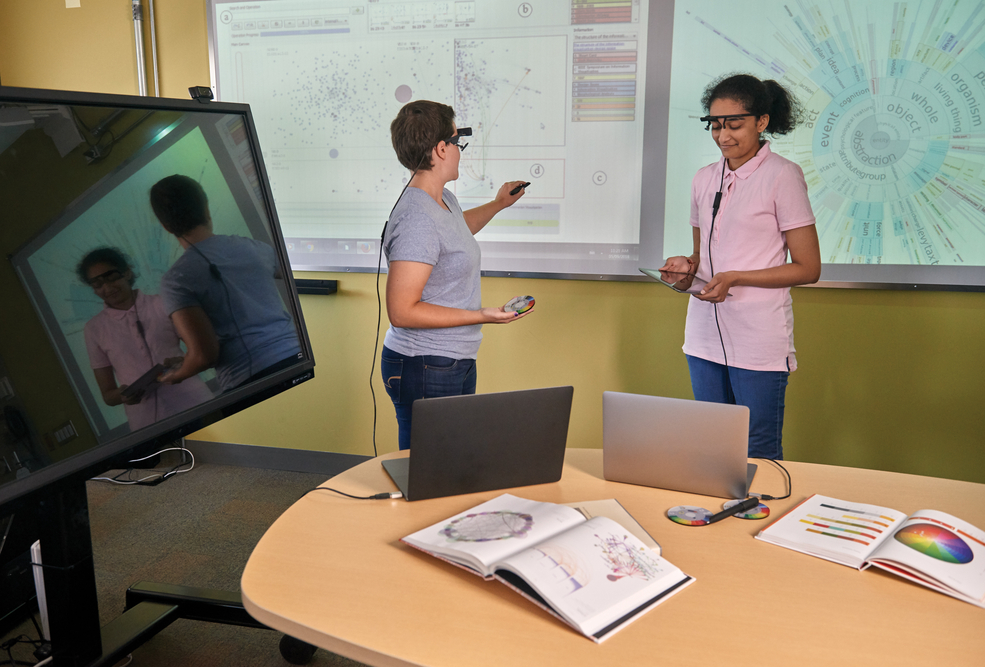 Students interacting with technology in the undergraduate game lab.