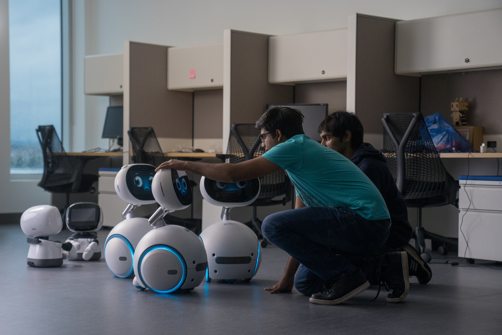 Students working with AI robots