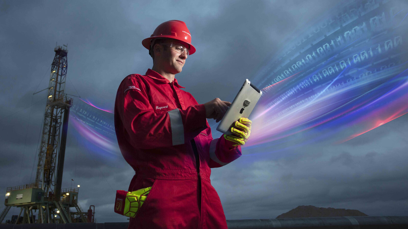 Image of a halliburton engineer looking at tablet
