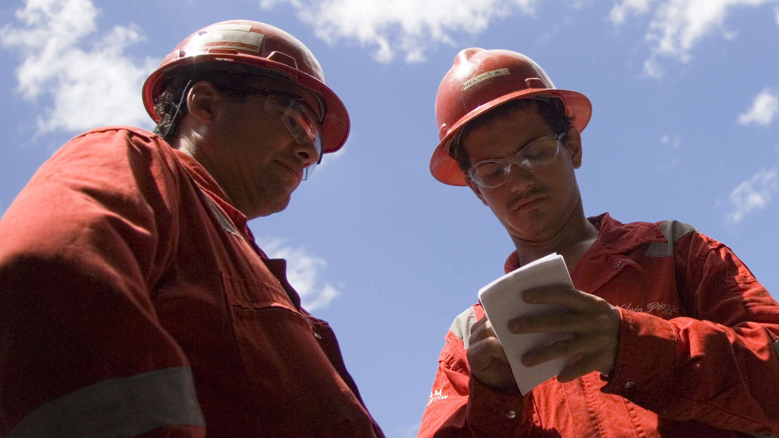 Two Halliburton engineers looking at a document.