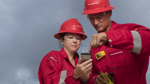 Halliburton employees collaborating using a digital device