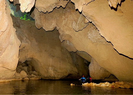 Float through an ancient cave system and gaze up at the rock formations around you on a cave-tubing adventure