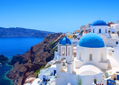 Explore the picturesque village of Oia, known for its iconic white stucco buildings