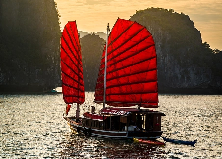 Glide through Ha Long Bay on a traditional junk boat and admire the limestone islands and emerald waters that define this UNESCO World Heritage Site