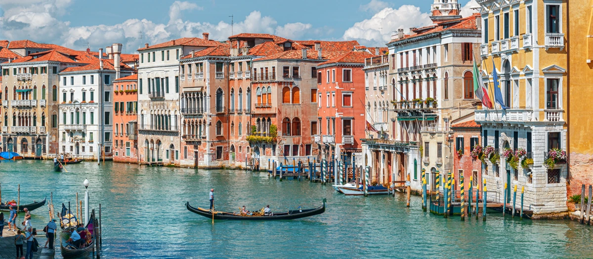 Venice Grand Canal lined with palazzos and gondolas, visited on Switzerland and Italy tours.