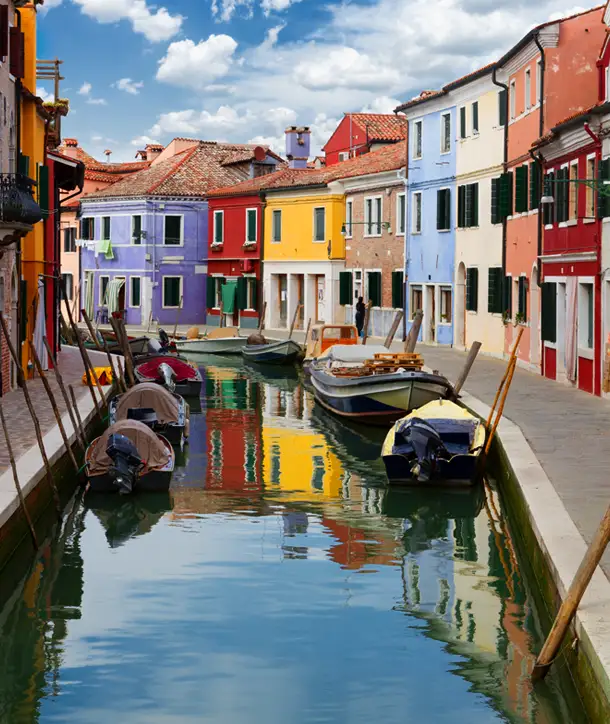 Canals of Venice surrounded by colorful homes on an EF Tours Bell'Italia trip.