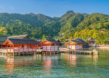 Journey by ferry to Miyajima Island to visit Itsukushima Shrine and examine its iconic floating torii gate
