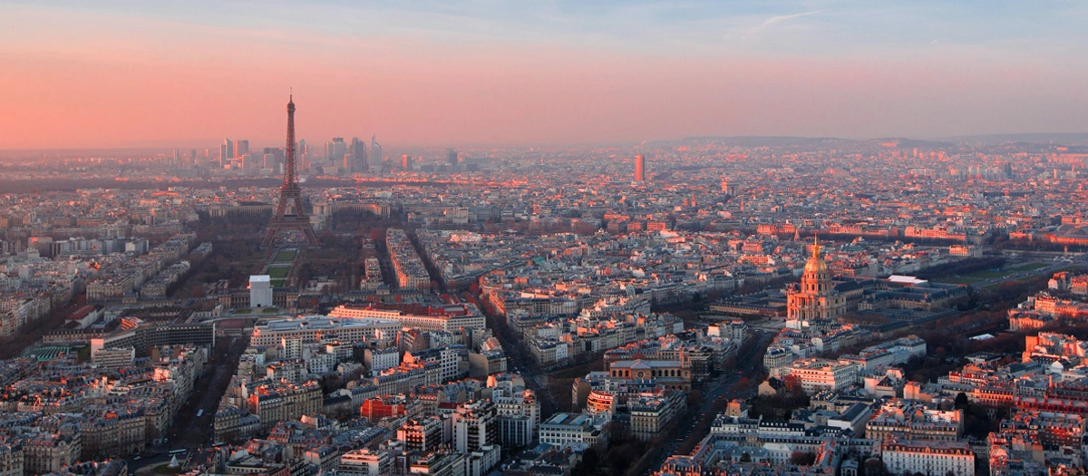 Paris rooftops and the Eiffel Tower at dusk on educational tours of Europe for adults.
