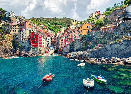 Explore Cinque Terre’s colorful seaside villages, perched dramatically above the sparkling Italian coast