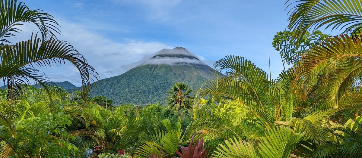 View of a volcano in costa rica through the jungle.