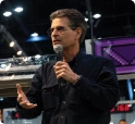 Dean Kamen speaks into a microphone. STEM travel brings inventions like his to life on an EF STEM trip.
