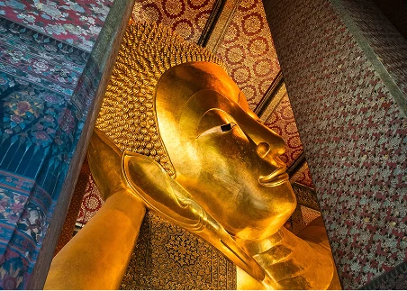 Visit Wat Pho in the heart of Bangkok and stand before its enormous golden Reclining Buddha 