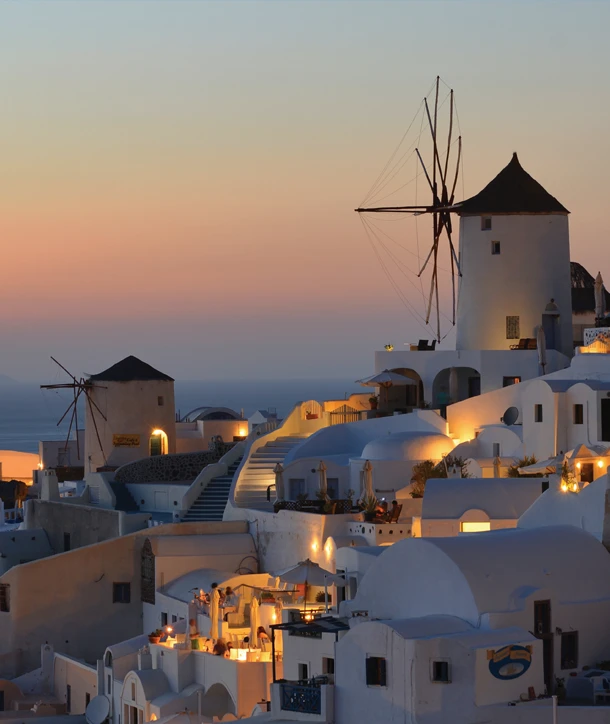 Athens and the islands at dusk with two windmills.